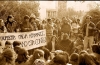 Students sitting around a large protest banner.
